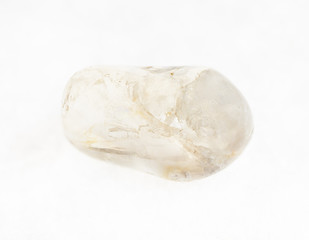 tumbled rock crystal ( quartz) gemstone on white