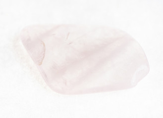 tumbled rose quartz stone on white