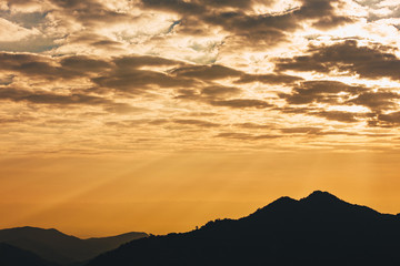 Beautiful sunset in the mountains. Landscape with sunlight shining through clouds