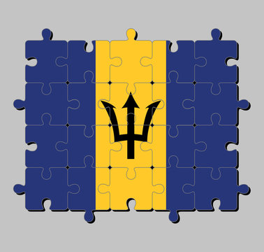 Jigsaw puzzle of Barbados flag in triband of ultramarine and gold with the black trident-head on the gold band. Concept of Fulfillment or perfection.