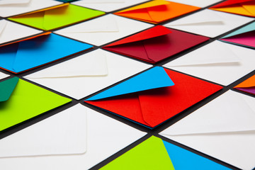 Composition with white and colored envelopes on the table.