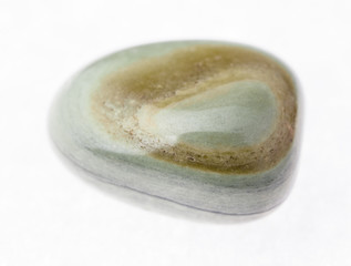 polished gray-green agate gemstone on white