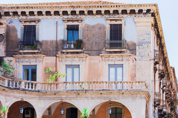 Fototapeta na wymiar Travel to Italy - historical street of Catania, Sicily, facade of ancient building