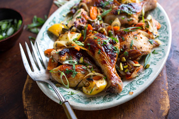 Close up of roasted chicken with vegetables served on plate