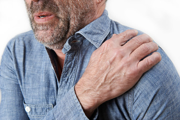 Studio Shot Of Man Suffering With Frozen Shoulder