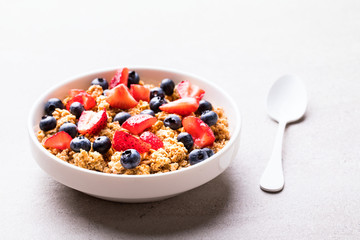 Granola Cereal bar with Strawberries and blueberries  on the Gray Background . Muesli Breakfast. Healthy Food sweet dessert snack. Diet Nutrition Concept. Vegetarian food.