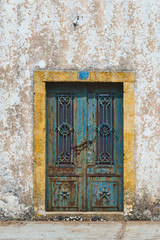 Old Ornate Iron Shut Doors Of An Inhabited, Deserted Rural House In Greece.