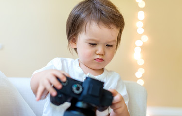 Toddler boy with a professional DSLR camera