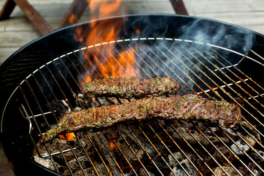 Close up of grilled skirt steak grilling on barbecue grill