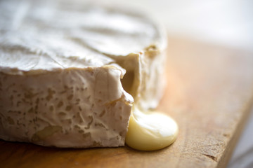 Close up of melting camembert cheese on cutting board