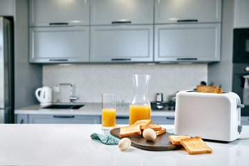 Continental breakfast - orange juice and toast on white table.