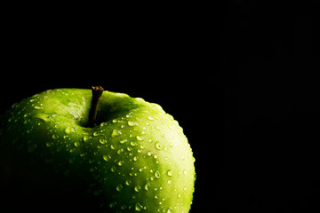 Green apple on black