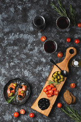 Bruschetta antipasto with olive and tomatoes top view