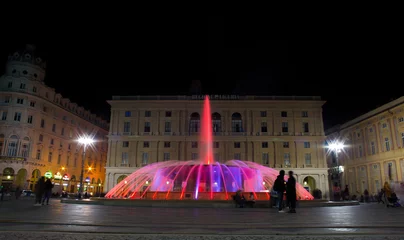Papier Peint photo Fontaine GENOA (GENOVA), ITALY, NOVEMBER 24, 2018 - View of the colorful fountain of De Ferrari Square by night in Genoa, the heart of the city, Italy.