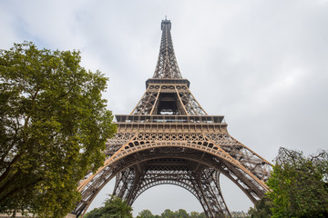 Fototapeta na wymiar View of Eiffel Tower in a day of a cloudy sky in Paris, France