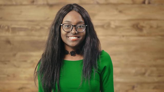 Black girl makes surprised questioning look and gesture, spreading hands