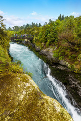 The powerful force of flowing and raging water of the Waikato River. Landscape at Huka Falls near Taupo, North Island, New Zealand.