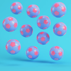 Pink flying soccer balls on bright blue background in pastel colors