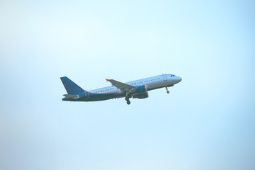 Fototapeta na wymiar takeoff of a passenger liner against a blue sky, toned