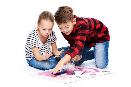 Brother and sister having fun painting with watercolors. Happy creative children at art class. Art therapy concept on white background.