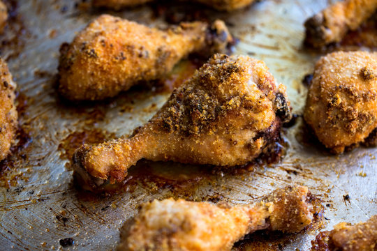 Close up of chicken with mustard bread crumbs in baking tray