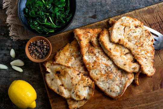 Close up of garlic chicken served on cutting board