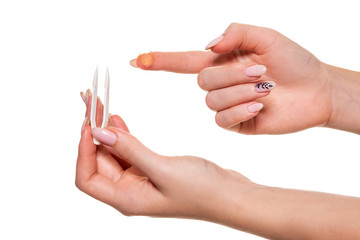 Contact eye lens. Close-up of woman holding white eye lense on finger.
