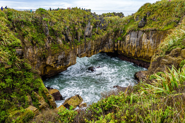 Naklejka na ściany i meble Sea and natural layered rock formations from erosion. Pancake Rocks and Blowholes, Paparoa National Park, West Coast, near Hokitika, New Zealand.