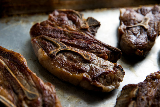 Close up of braised lamb chops on baking tray