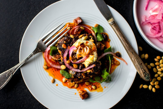 Close up of black bean, chorizo with pickled onions served on plate