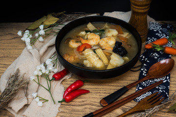 Bowls of Asian soup noodles and vegetables with Chopstick