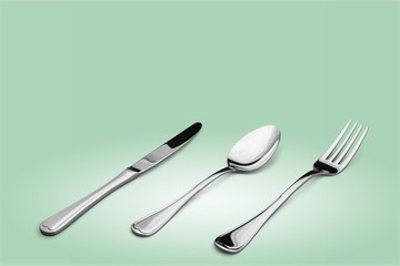 Fork, spoon and knife on blue background