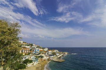 Naklejka na ściany i meble beautiful fishing village with traditional greek houses and romantic harbor in the popular holiday destination Armenistis, Ikaria, Greece