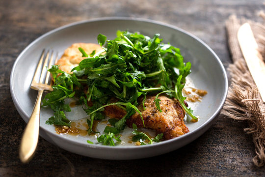 Close up of lemon and garlic chicken with mushrooms served on plate