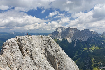 Fototapeta na wymiar Climbers at the summit of a mountain (Ehrwalder Sonnenspitze) near Ehrwald, Tyrol, Austria. Wetterstein mountain range with Zugspitze in the background