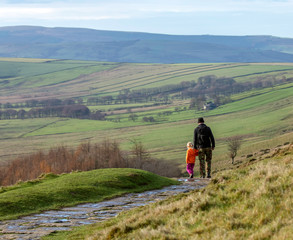 Obraz premium FATHER AND DAUGHTER WALKING IN THE UK COUNTRYSIDE
