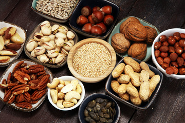 nuts composition on rustic table with walnut and peanut.