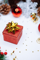 Christmas card: red gift box and Christmas tree branch on white background