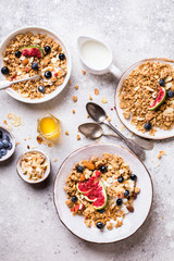 Muesli with Nuts Yogurt and fresh Figs Blueberry on the gray Background.Granola Healthy Breakfast. Sweet food Dessert. Snack  Dry Diet Nutrition Concept.Top View. Flat Lay.