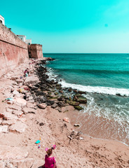 View of the old walls of Monopoli on the beach (also called Portavecchia). Panorama of Monopoli in...
