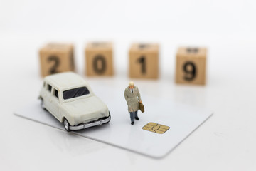 Fototapeta premium Miniature people: Businessman standing front of wood block 2019. Image use for business concept and happy new year.