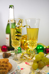 Christmas dinner with two glasses of sparkling drink to celebrate the new year