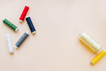 Hanks of multi-coloured threads for embroidery on pastel background.multi colored embroidery thread yarns. Flat lay of colored thread rolls for sewing, Sewing and needlework concept.Copy space