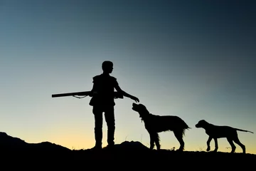 Fototapeten hunting man and his faithful companions hunting preparation with dogs © emerald_media
