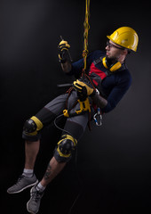 stylish climber Builder hands and works with the tool. black background. copy past