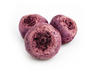 Three raw purple beetroots, isolated on white background.