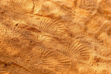 shoe marks on bright orange sand