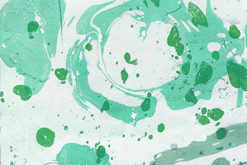 Colorful marble ink texture with abstract washes and brush strokes on the white paper background.