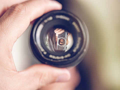 Reflection of woman in lens