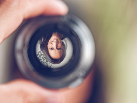 Reflection of woman in lens
